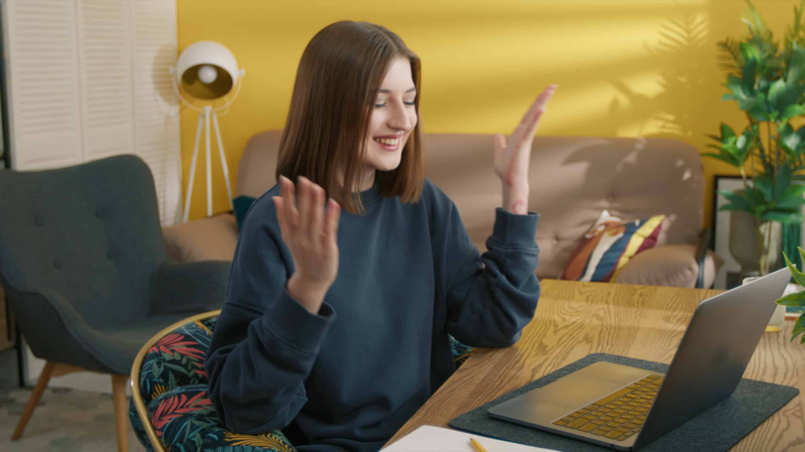 surprised-woman-reading-good-news-on-the-laptop-screen-happy-girl-celebrating-success--SBI-349511664